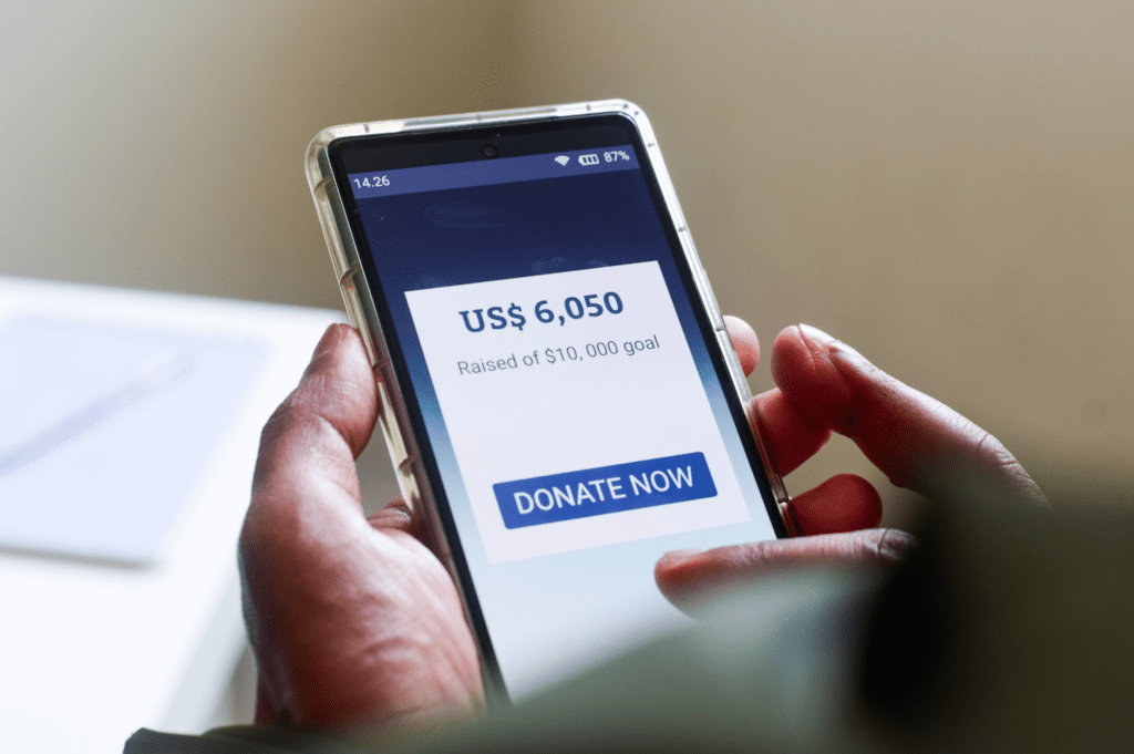 Person making a donation through their cell phone