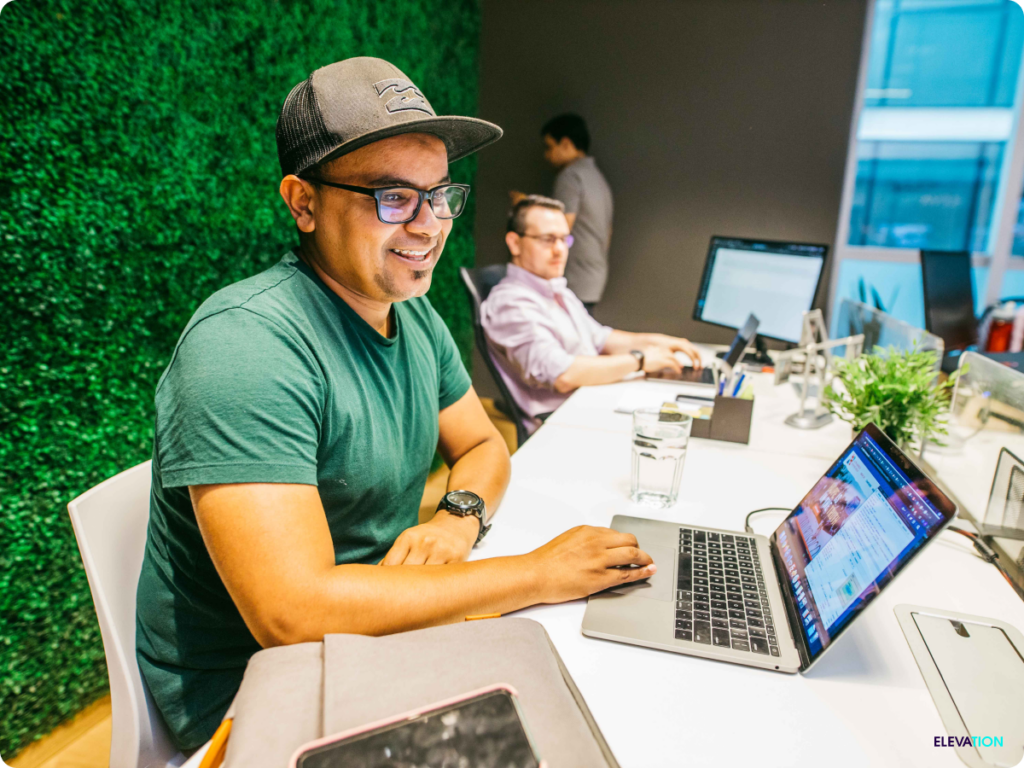 Male employees working at desks in marketing agency